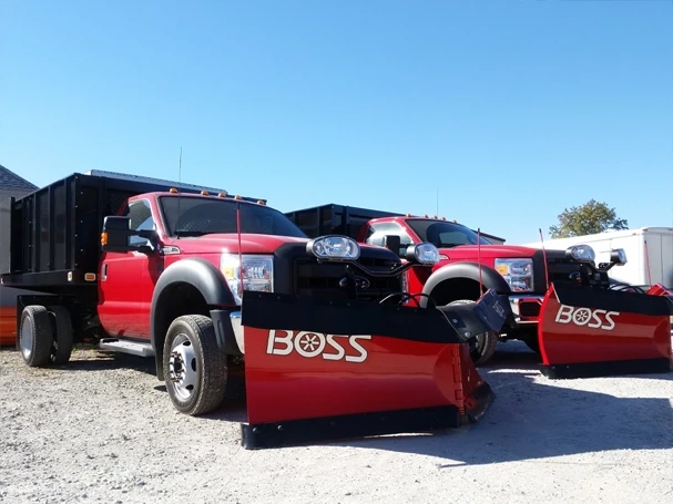 BOSS Plow Equipped Trucks — Mid-State Truck Equipment Fishers Greenfield IN Two red Ford trucks equipped with BOSS snow plows at Mid-State Truck Equipment in Fishers and Greenfield, Indiana