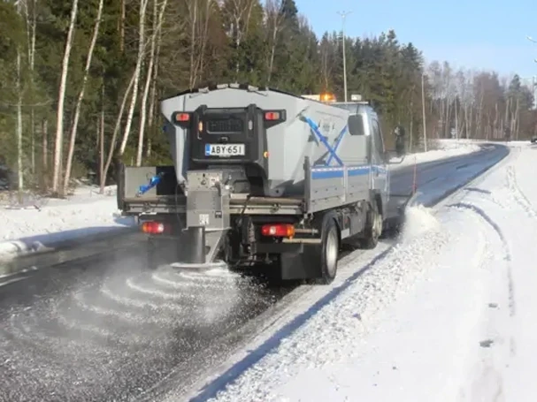 Hilltip Sweeper Spreader Combo — Mid-State Truck Equipment Fishers Greenfield IN Hilltip sweeper and spreader combination unit clearing a snowy road, equipment sold by Mid-State Truck Equipment in Fishers and Greenfield, Indiana
