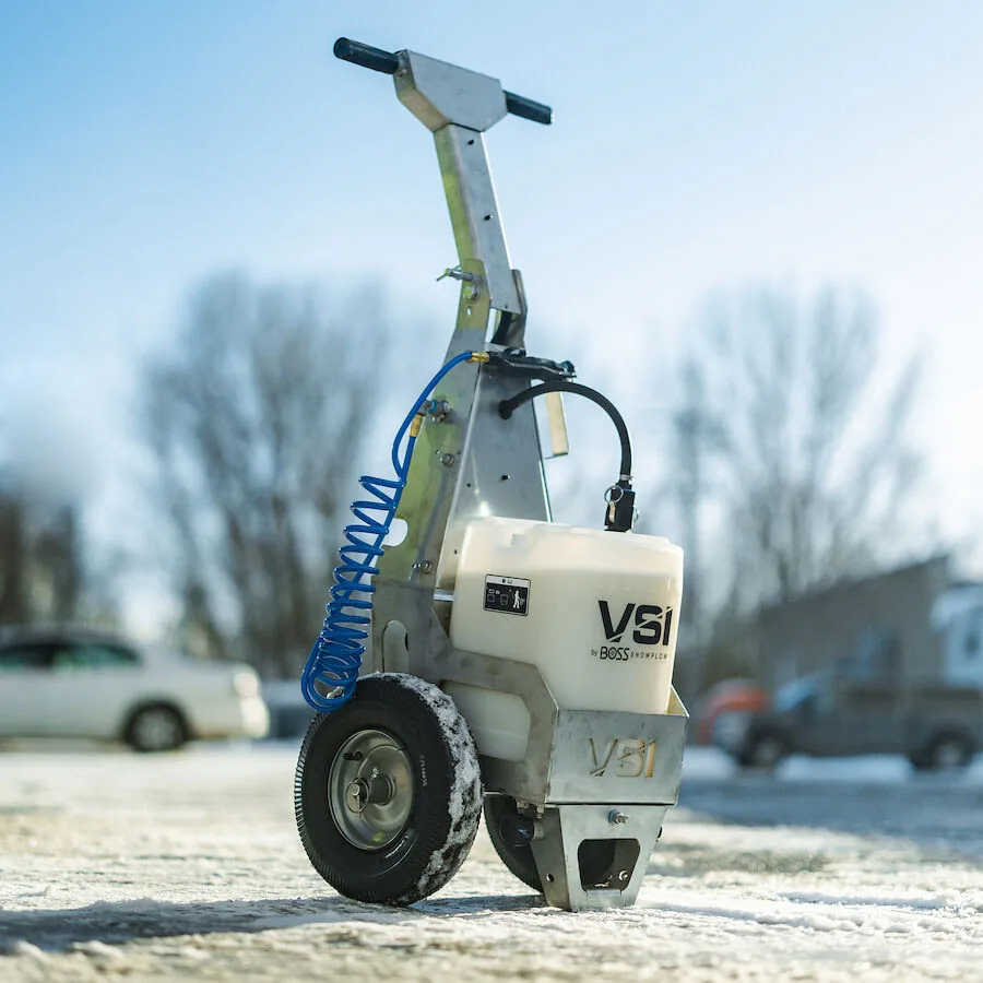 BOSS VSI Walk-Behind Liquid Sprayer | Mid-State Truck Equipment BOSS VSI walk-behind liquid deicing sprayer on a snowy parking lot, ice control equipment sold by Mid-State Truck Equipment in Fishers and Greenfield, Indiana